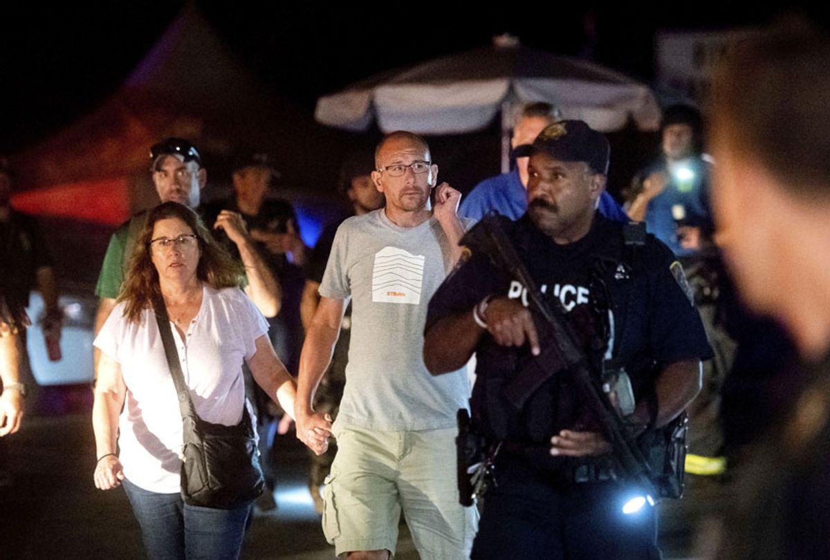 Police officers escort people from Christmas Hill Park following a deadly shooting during the Gilroy Garlic Festival, in Gilroy, Calif., on Sunday, July 28, 2019.  (AP/Noah Berger)
