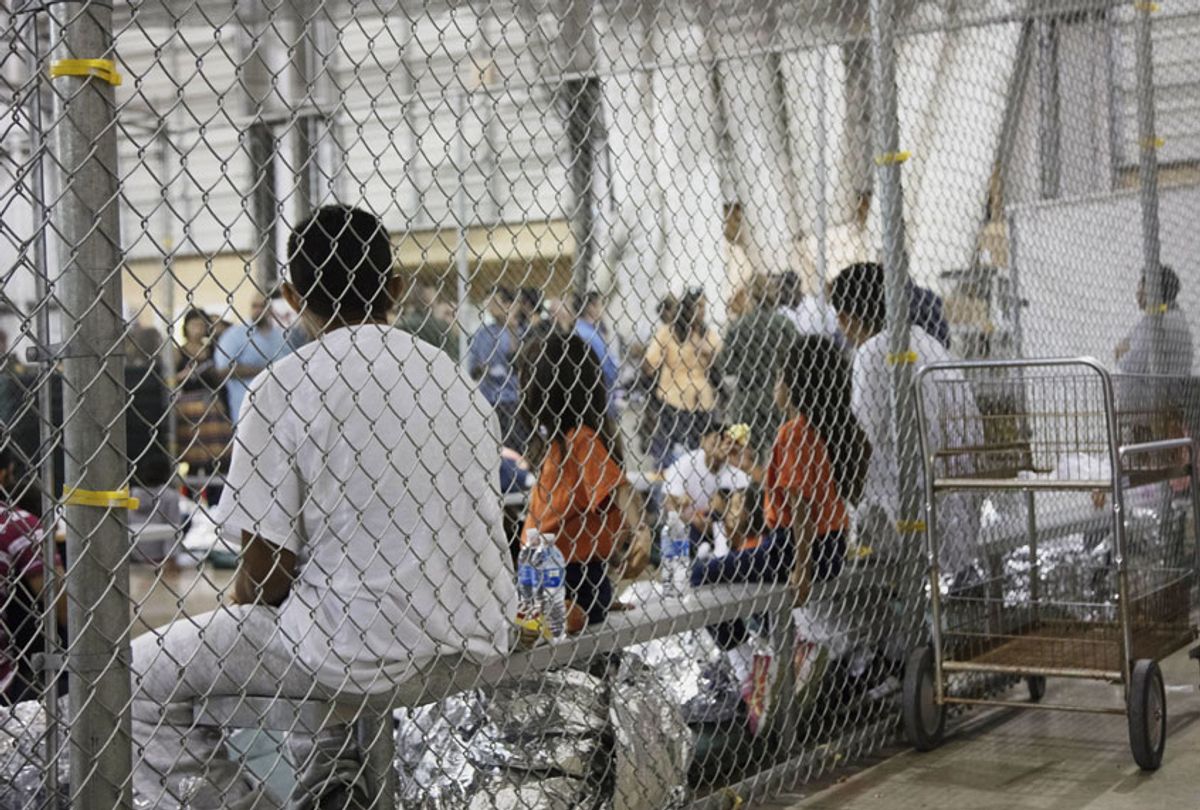 In this photo provided by U.S. Customs and Border Protection, people who've been taken into custody related to cases of illegal entry into the United States, sit in one of the cages at a facility in McAllen, Texas, Sunday, June 17, 2018. (U.S. Customs and Border Protection's Rio Grande Valley Sector via AP)