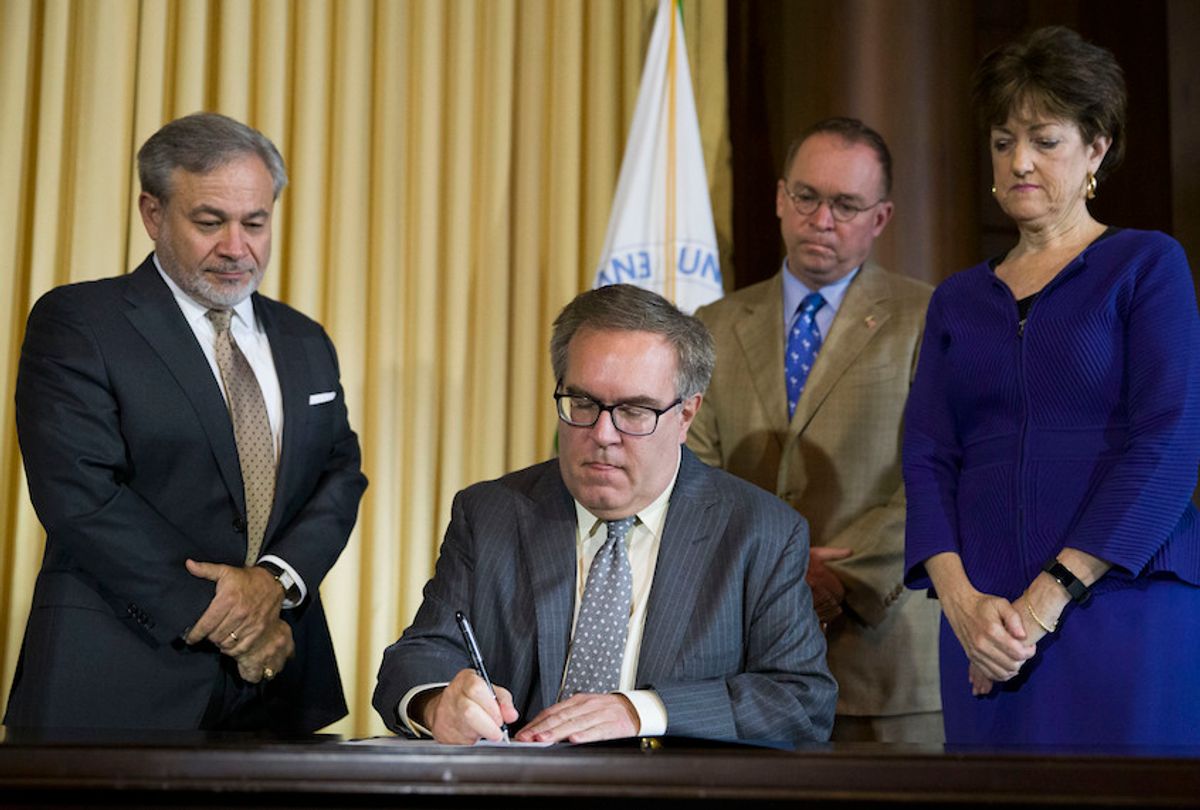 Deputy Secretary of Energy Dan Brouillette, left, Acting White House Chief of Staff Mick Mulvaney, and Chairman of the Council on Environmental Quality (CEQ) Mary B. Neumayr, stand as EPA administrator Andrew Wheeler signs the Affordable Clean Energy Rule during a media availability at the Environmental Protection Agency, Wednesday, June 19, 2019, in Washington.  (AP Photo/Alex Brandon)