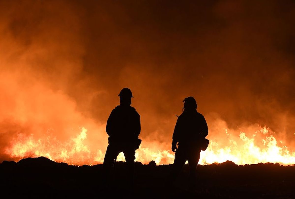 Firefighters light backfires as they try to contain the Thomas wildfire which continues to burn in Ojai, California on December 9, 2017.
Brutal winds that fueled southern California's firestorm finally began to ease Saturday, giving residents and firefighters hope for respite as the destructive toll of multiple blazes came into focus. / AFP PHOTO / MARK RALSTON        (Photo credit should read MARK RALSTON/AFP/Getty Images) (Mark Ralston/AFP/Getty Images)