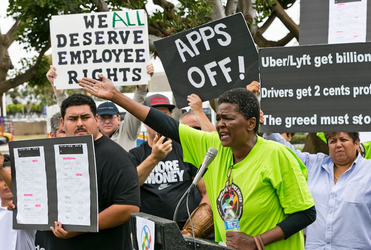Uber driver Estaphanie St. Just joins drivers for ride-hailing giants Uber and Lyft, as they hold a rally at a park near Los Angeles International Airport, Wednesday, May, 8, 2019, in Los Angeles.  (AP Photo/Damian Dovarganes)