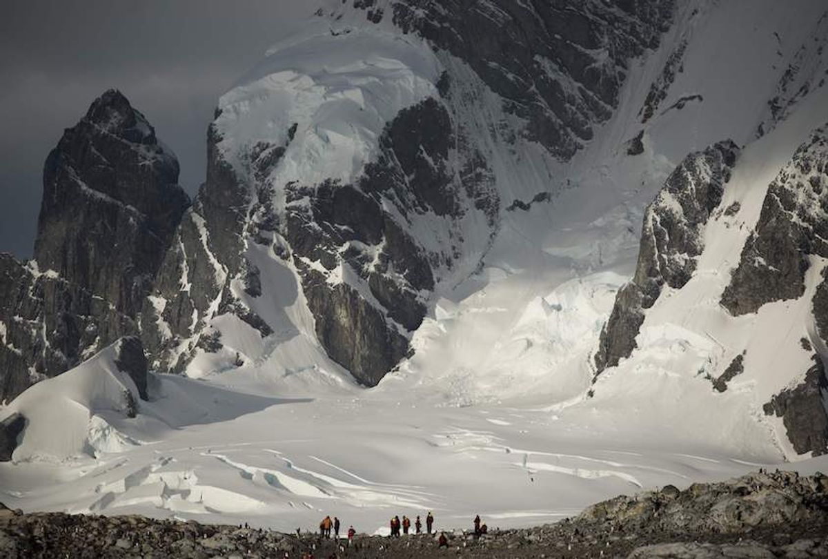 Tourists visit Cuverville Island, Antarctica, on March 04, 2016. The Antarctic tourism industry is generally considered to have begun in the late 1950s when Chile and Argentina took more than 500 fare-paying passengers to the South Shetland Islands aboard a naval transportation ship. The concept of 'expedition cruising,' coupled with education as a major theme, began when Lars-Eric Lindblad led the first traveler's expedition to Antarctica in 1966. Prior to this, human activity in Antarctica was limited to the early explorers, those seeking fortune in the exploitation of seals and whales, and more recently to scientific research and exploration. Antarctica's physical isolation, extreme climate and remarkable wilderness values are a great part of its attraction for tourism. AFP PHOTO/EITAN ABRAMOVICH / AFP / EITAN ABRAMOVICH        (Photo credit should read EITAN ABRAMOVICH/AFP/Getty Images) (Eitan Abramovich/AFP/Getty Images)