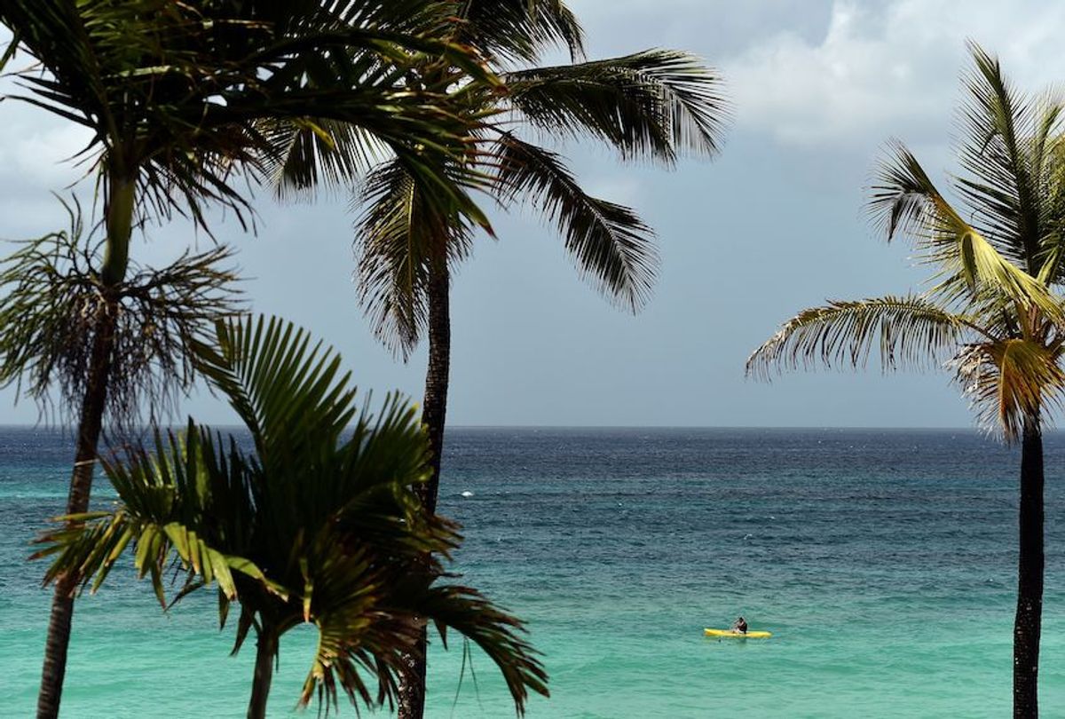 Tourists paddles by near a beach in Bridgetown, Barbados on May 4, 2015. AFP PHOTO/JEWEL SAMAD        (Photo credit should read JEWEL SAMAD/AFP/Getty Images) (Jewel Samad/AFP/Getty Images)