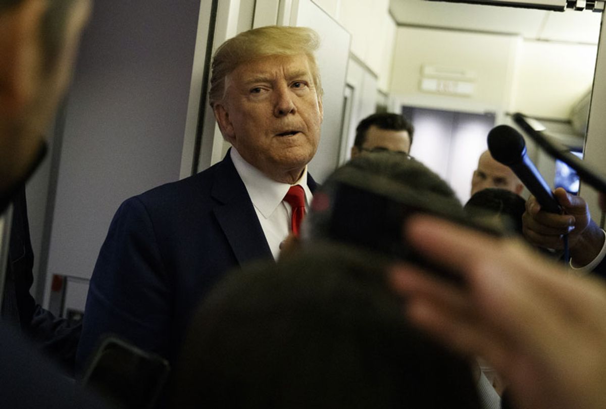 President Donald Trump talks to reporters aboard Air Force One after visiting Dayton, Ohio and El Paso, Texas, Wednesday, Aug. 7, 2019.  (AP/Evan Vucci)