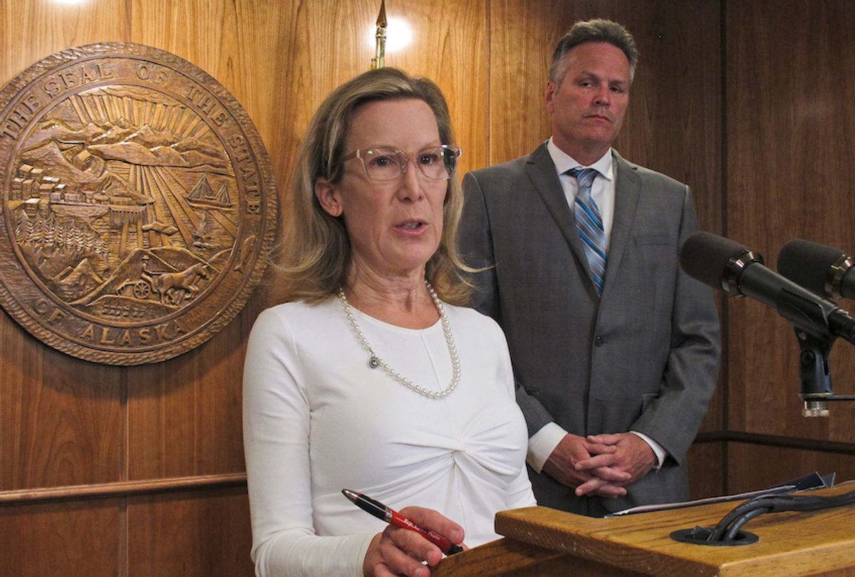 Donna Arduin, director of the Office of Management and Budget, at podium, comments on the governor's state budget vetoes at the state capitol in Juneau, Alaska Friday, June 28, 2019. At right, with Alaska Gov. Mike Dunleavy. The university system, health and social service programs and public broadcasting were among the areas affected by vetoes. The budget agreed to by the House and Senate cut state support for the university system by a fraction of what Dunleavy proposed. Lawmakers have the ability to override budget vetoes if they can muster sufficient support. (AP Photo/Becky Bohrer) (AP Photo/Becky Bohrer)