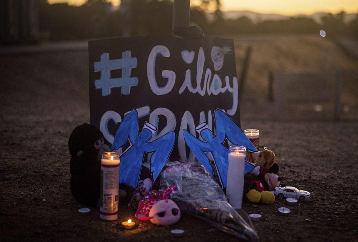 Candles burn at a makeshift memorial for Gilroy Garlic Festival shooting victims outside the festival grounds, Monday, July 29, 2019, in Gilroy, Calif.  (AP/Noah Berger)