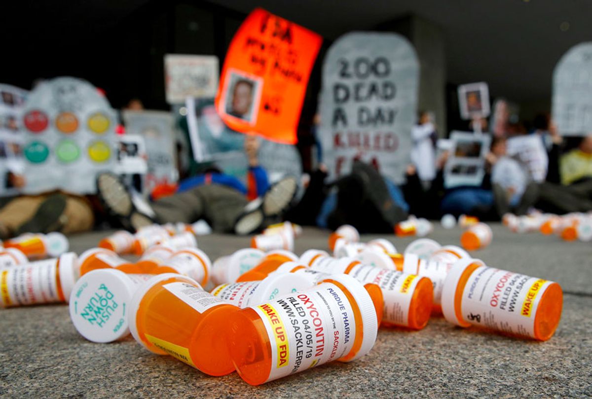 OxyContin pill bottles scattered in front of protestors of the opioid crisis. (AP Photo/Patrick Semansky)