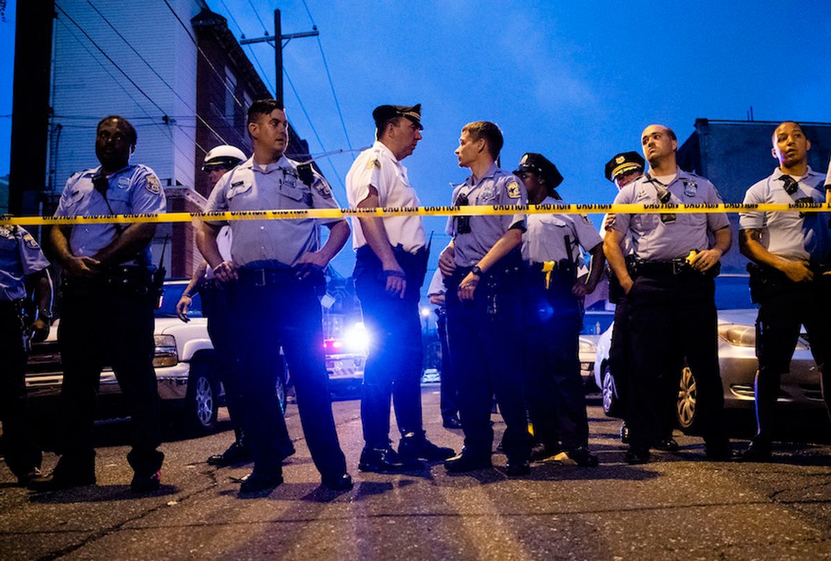 Officers gather for crowd control as they investigate a shooting in Philadelphia, Wednesday, Aug. 14, 2019. (AP Photo/Matt Rourke)