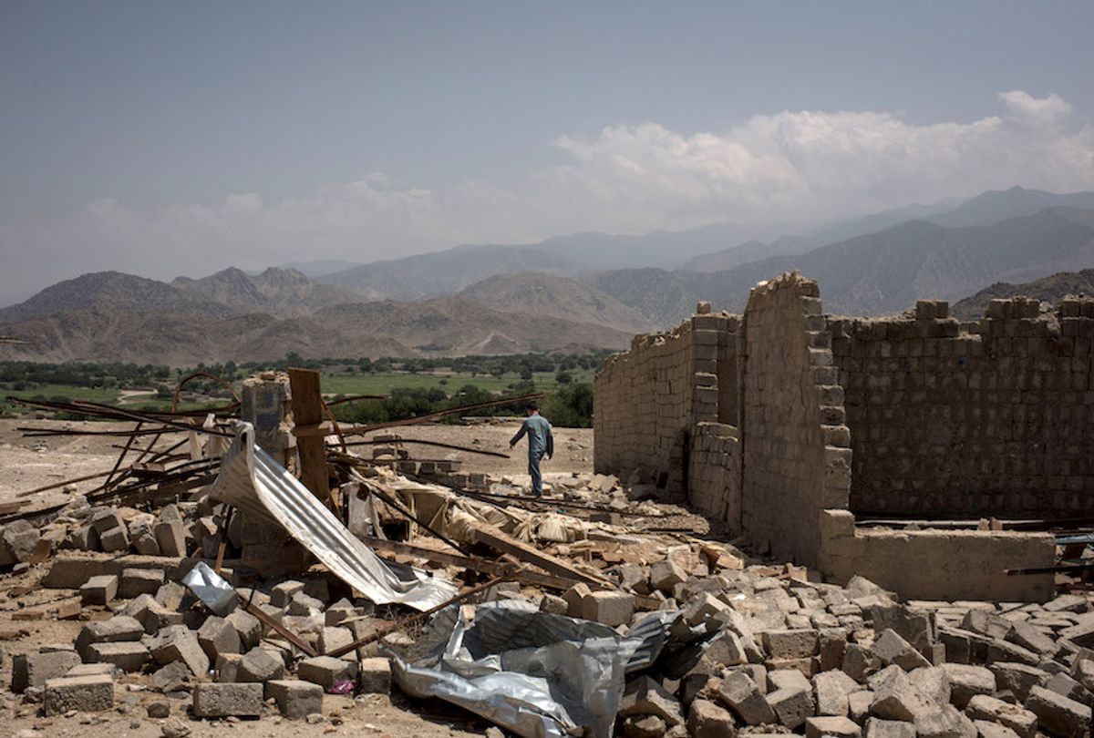 A boy walks through buildings damaged from fighting on July 15, 2017 in Shadal Bazaar, Afghanistan.  (Andrew Renneisen/Getty Images)