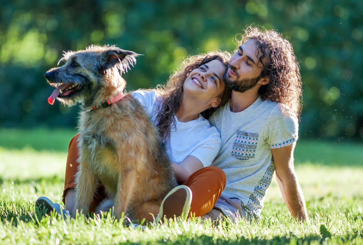 Young couple with their dog in the park (Getty Images/iStock)