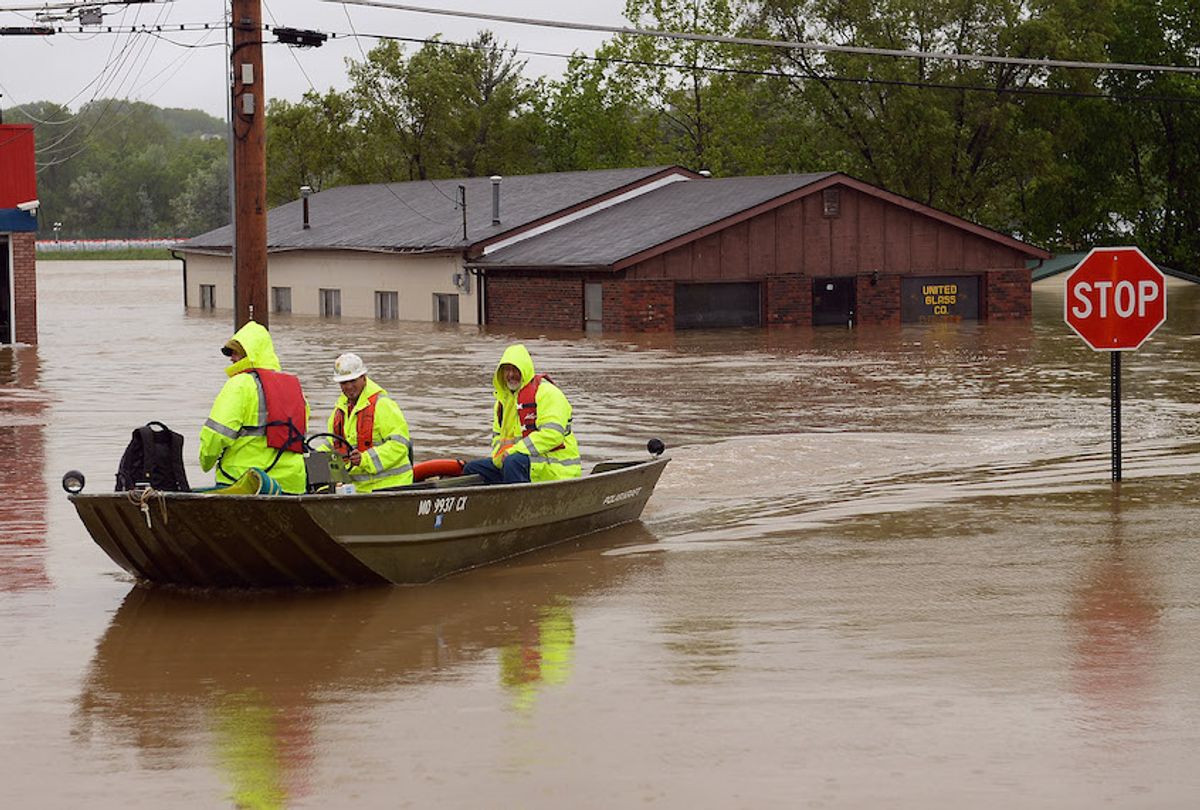Metropolitan Sewer District workers are seen being boated to shore at the completion of their shift as they monitor the nearby levee along the banks of the Meramec River on May 4, 2017 in Fenton, Missouri. (Michael B. Thomas/Getty Images)