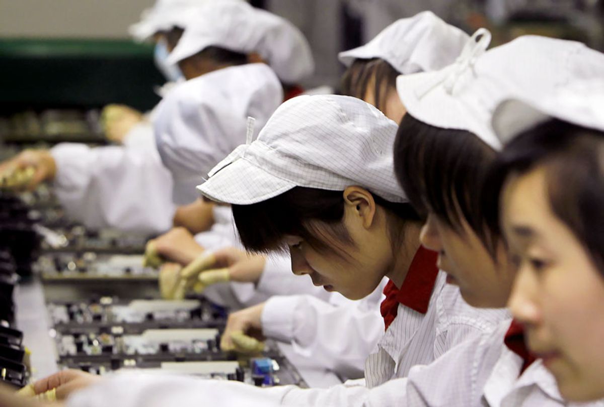 In this May 26, 2010 file photo, staff members work on the production line at the Foxconn complex in the southern Chinese city of Shenzhen, southern China.  (AP Photo/Kin Cheung)