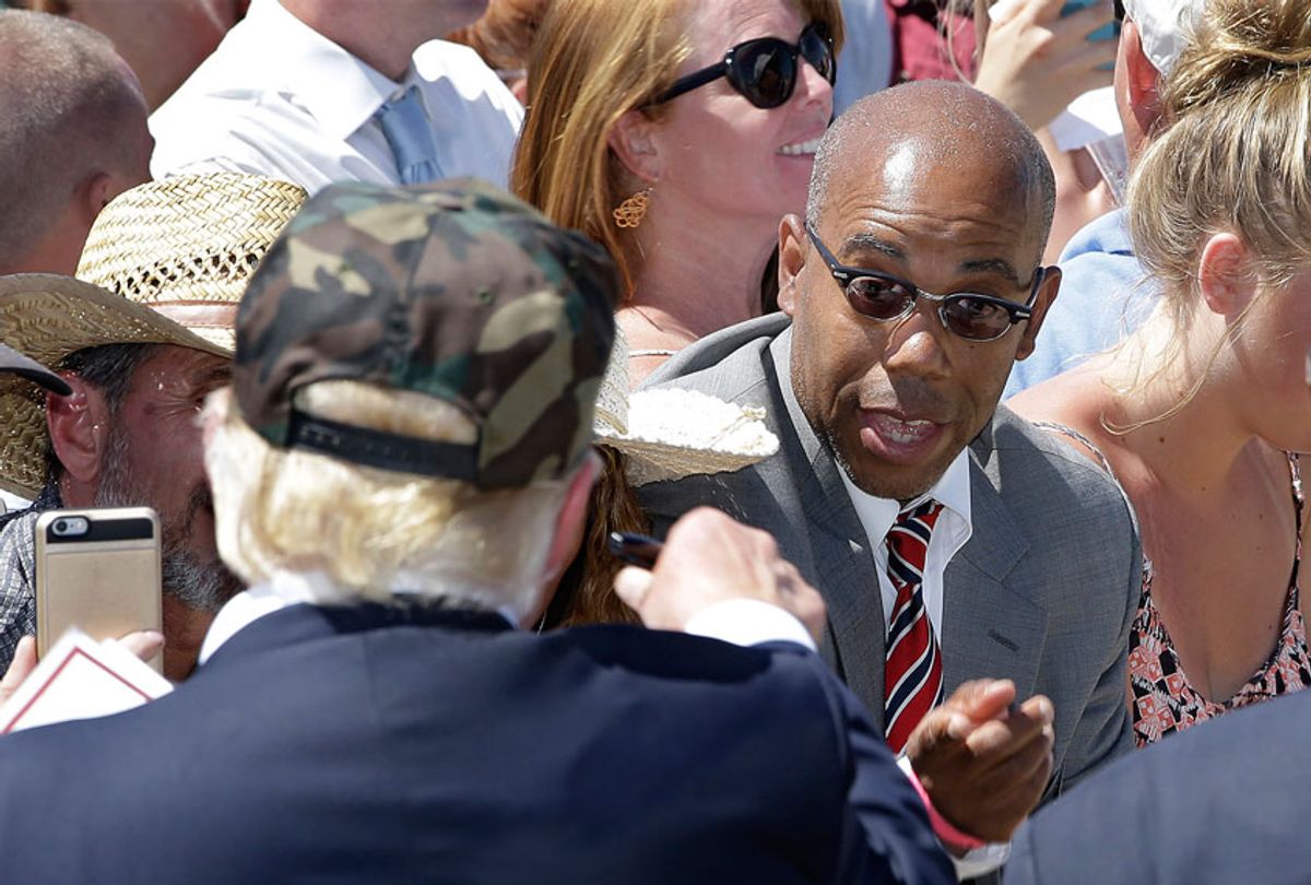 In this photo taken Friday, June 3, 2016, Republican presidential candidate Donald Trump, left, talks to Gregory Cheadle as he leaves a campaign rally at the Redding Municipal Airport, in Redding, Calif. Cheadle, whom Trump singled out while calling him "my African-American," said Monday that he is now the target of harsh criticism, including comments he feels are more racist than the remark by the presumptive Republican presidential nominee. Cheadle also said Monday that he was not there to back Trump and that he is considering other possibilities as well, including Democratic candidate Sen. Bernie Sanders. (AP Photo/Rich Pedroncelli)