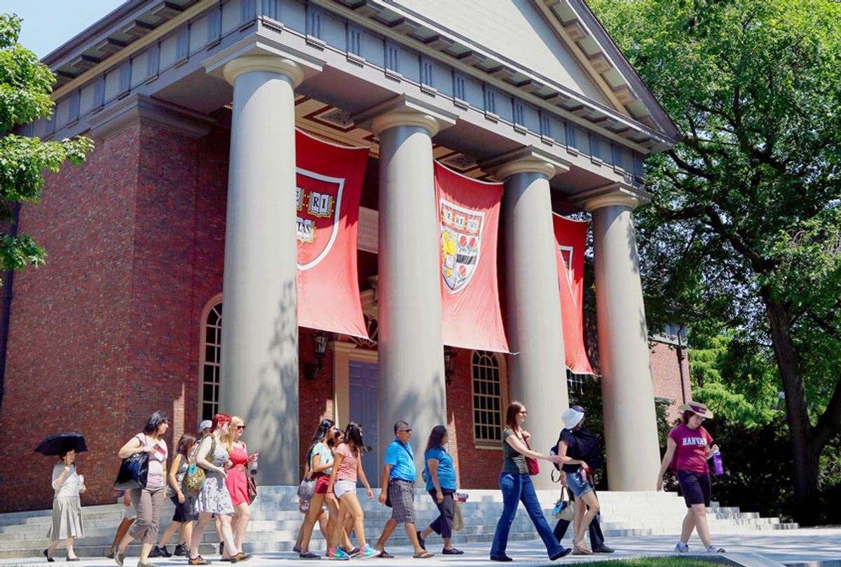 A tour group walks through the campus of Harvard University in Cambridge, Mass. (AP Photo/Elise Amendola)