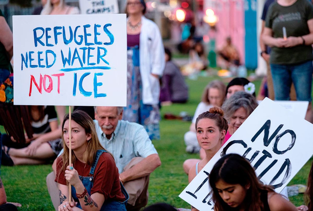 People gather to protest the treatment of immigrants in detention centers during the "Lights for Liberty: A Vigil to End Human Concentration Camps" event in El Paso, Texas, on July 12, 2019 (Getty/ LUKE MONTAVON)