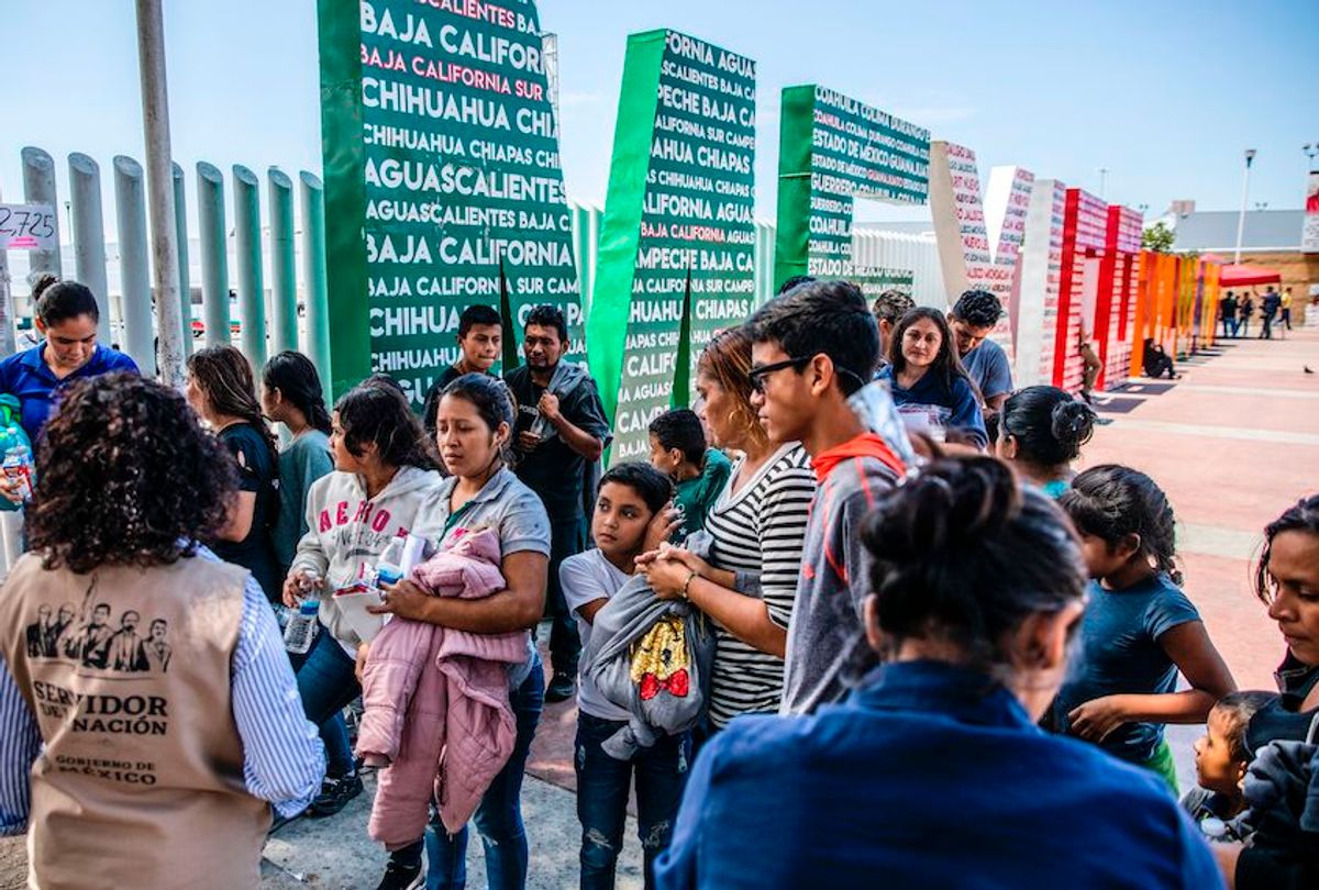Central American migrants, part of a group of 87 people deported from US, gather at the El Chaparral border crossing before being transported to a shelter in Tijuana, Mexico, on July 22, 2019. - According to Mexican Foreign Minister Marcelo Ebrard, authorities of Mexico and US will meet in 45 days in Washington to evaluate again the efforts of Mexico in the fight against illegal immigration in the US southern border. (Photo by Eduardo Jaramillo Castro / AFP)        (Photo credit should read EDUARDO JARAMILLO CASTRO/AFP/Getty Images) (Eduardo Jaramillo Castro/AFP/Getty Images)