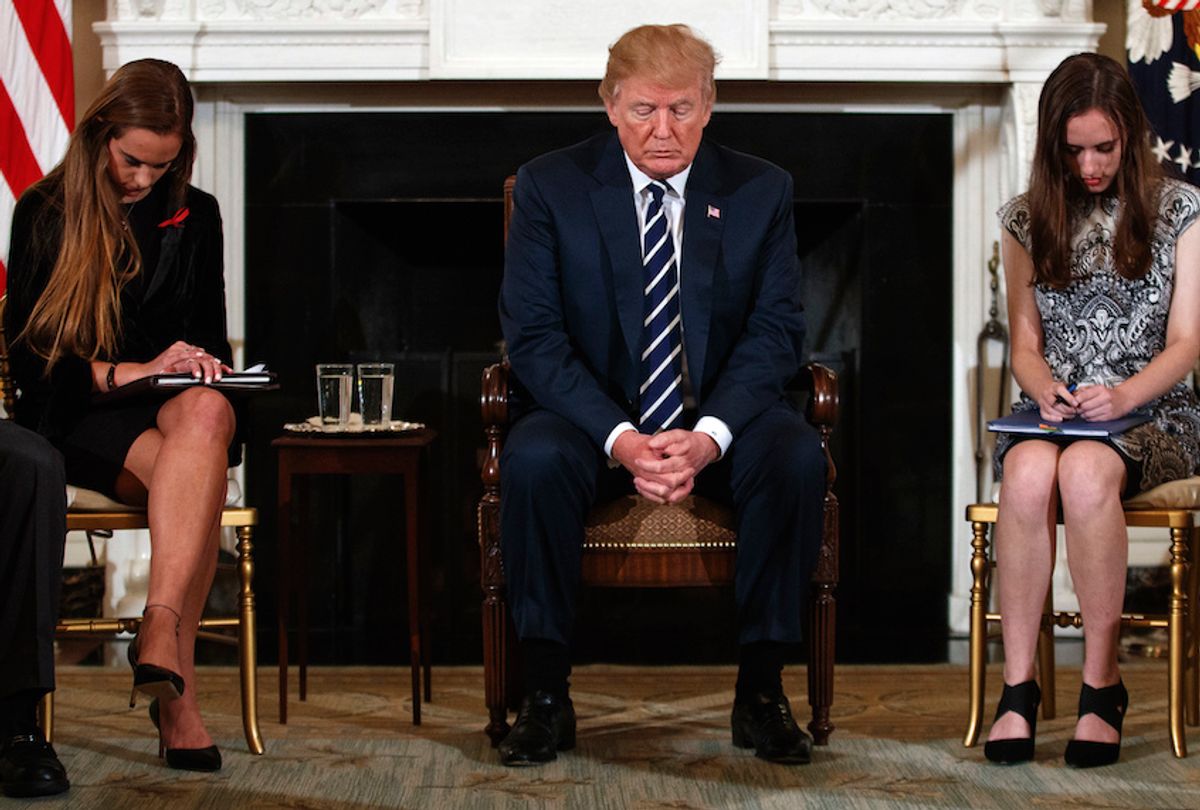 President Trump prayed with two students from Marjory Stoneman Douglas High School in Feb. 21, 2018 before a discussion on gun violence. (AP Photo/Carolyn Kaster)