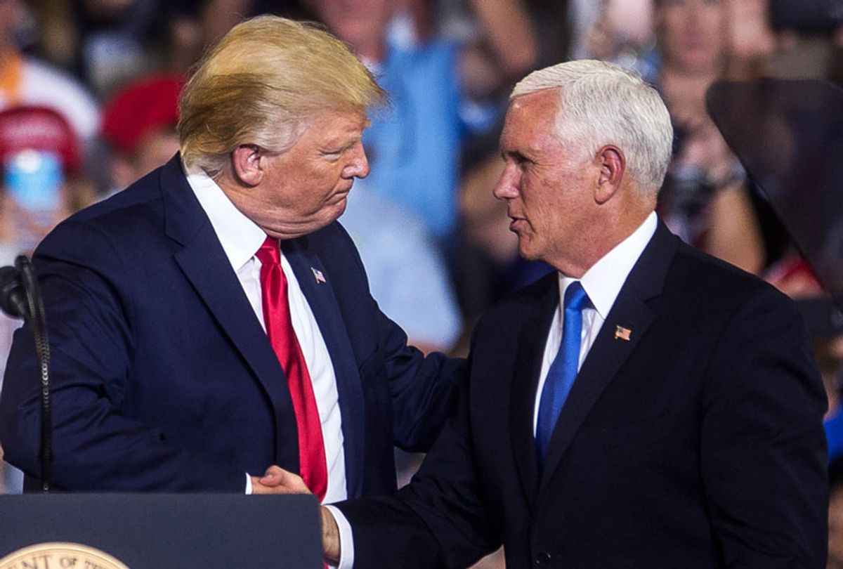 President Donald Trump shakes hands with Mike Pence, U.S. Vice President, as he takes the podium before speaking during a Keep America Great rally on July 17, 2019 in Greenville, North Carolina. (Zach Gibson/Getty Images)