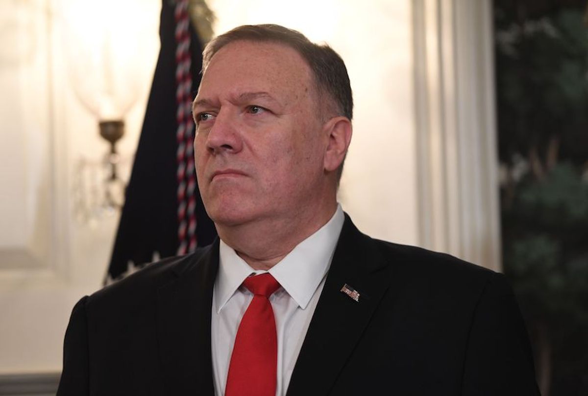 US Secretary of State Mike Pompeo listens as US President Donald Trump speaks about Syria in the Diplomatic Reception Room at the White House in Washington, DC, October 23, 2019. - President Donald Trump announced on Wednesday the United States would be lifting sanctions on Turkey, hailing the success of a ceasefire along its border with Syria."Earlier this morning, the government of Turkey informed my administration that they would be stopping combat and their offensive in Syria and making the ceasefire permanent," he said in a televised address from the White House. (Photo by SAUL LOEB / AFP) (Photo by SAUL LOEB/AFP via Getty Images) (Saul Loeb/AFP via Getty Images)