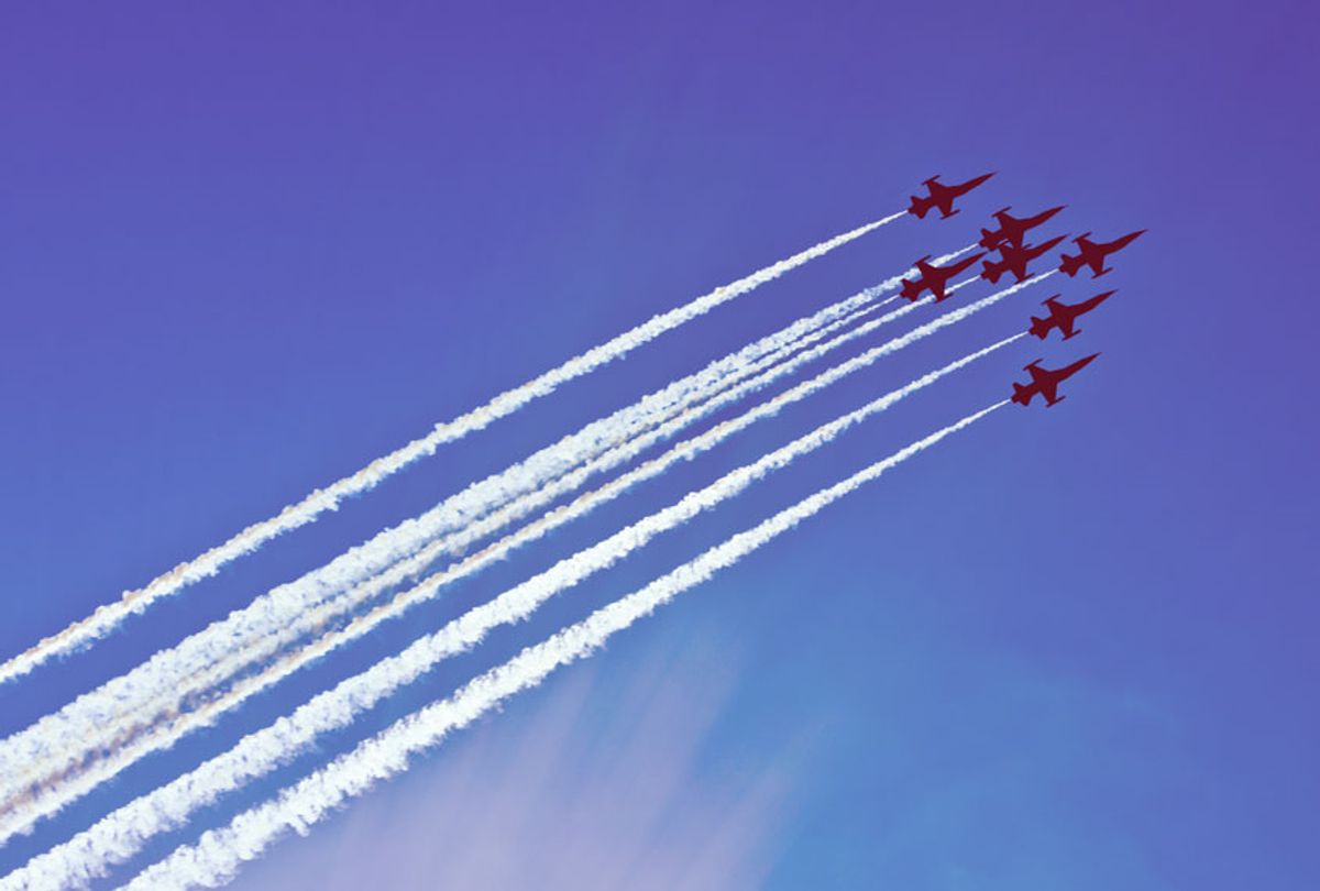 Silhouettes of seven fighter planes with exhaust trailing behind (Getty Images)