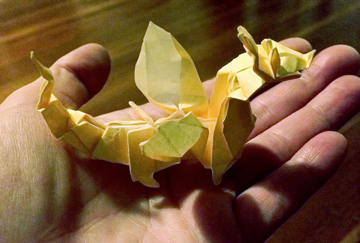 The tiny paper dragon, in the palm of Rene’s hand (photo provided by PR firm)