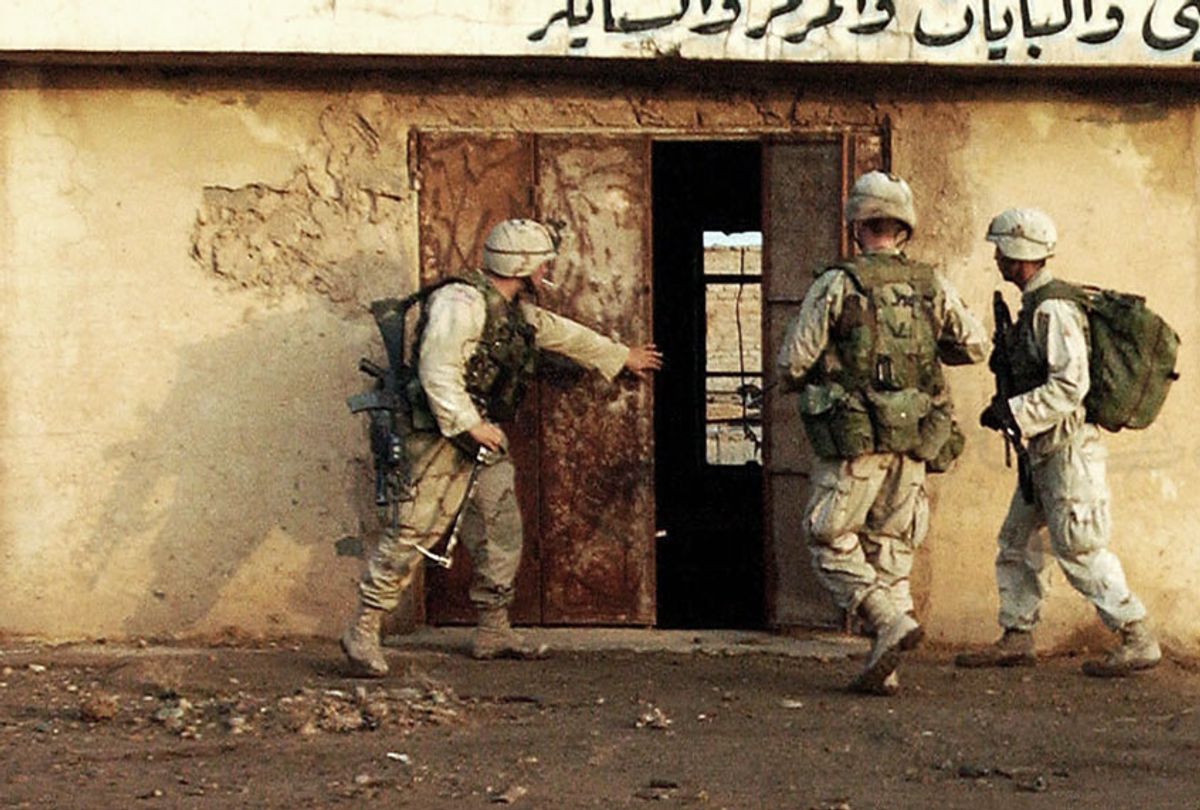 U.S. soldiers from 1-8, 3rd Brigade, of the 4th Infantry Division search a store in the industrial section of Samarra, 17 December, 2003. A major operation named Operation Ivy Blizzard began early Wednesday morning which targeted a large number of wanted men and suspected weapons caches (STEFAN ZAKLIN/AFP via Getty Images)