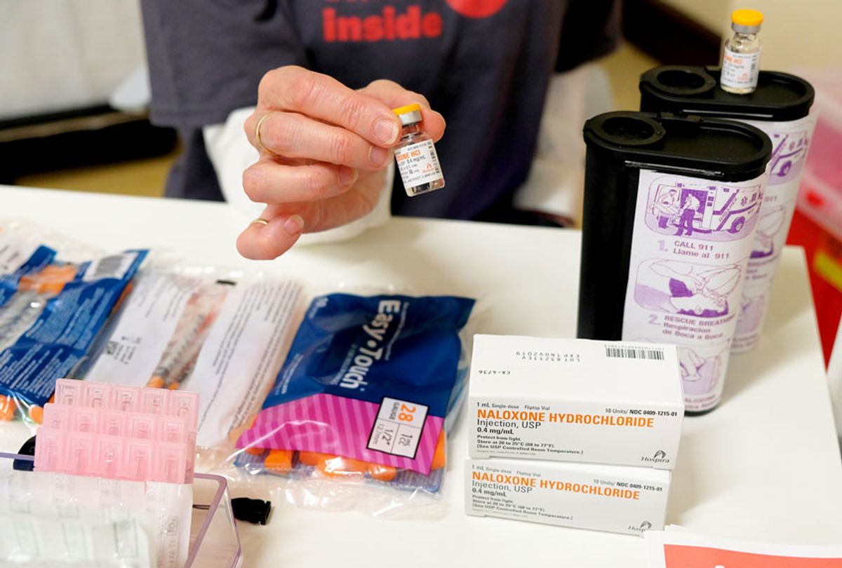 In this photo taken Wednesday, Aug. 29, 2018, Linda Montel shows off supplies on a check in desk at Safer Inside, a realistic model of a safe injection site in San Francisco. The model is an example of a supervised, indoor location where intravenous drug users can consume drugs in safer conditions and access treatment and recovery services.  (AP Photo/Eric Risberg)