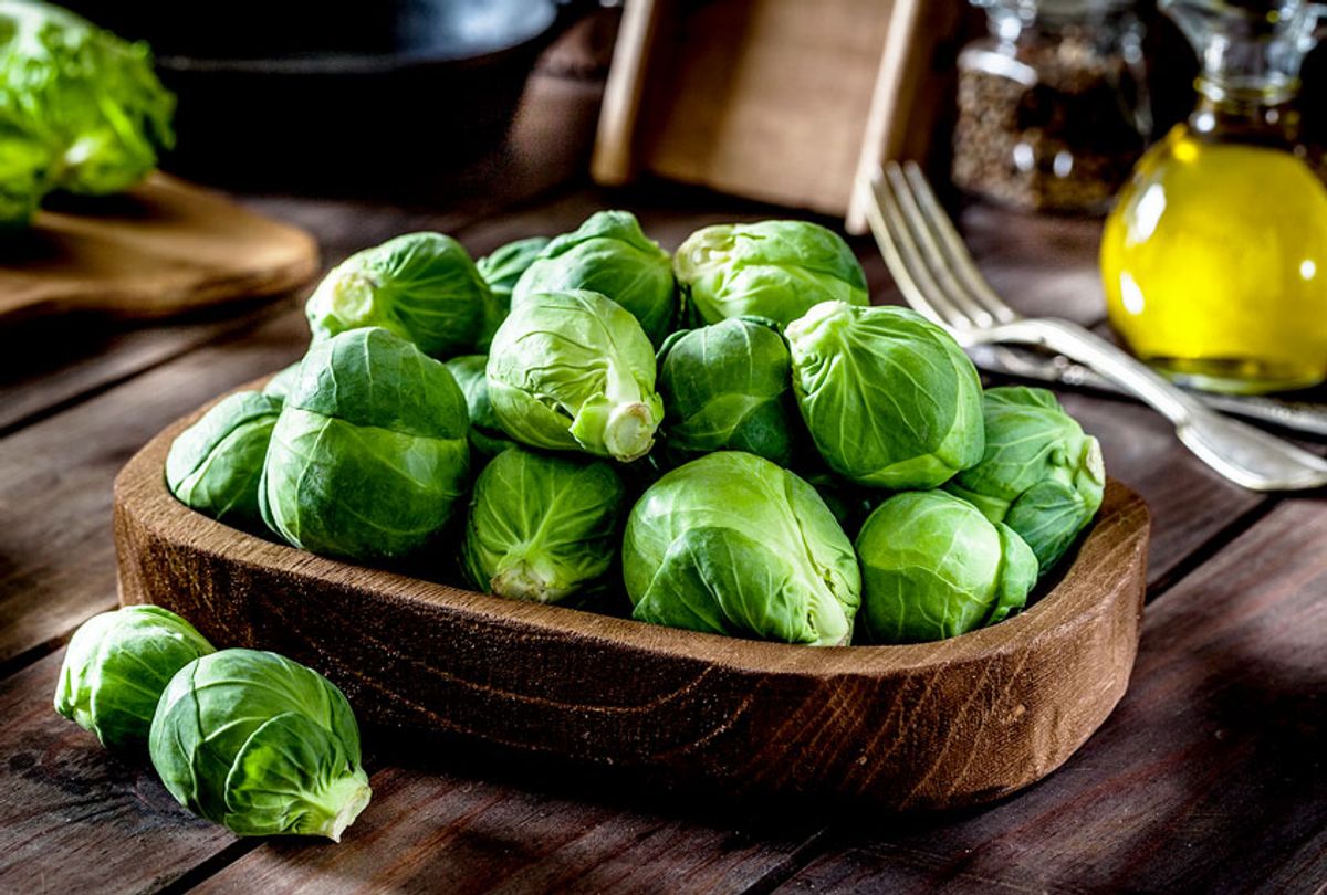Fresh organic Brussels sprouts in a wooden tray (Getty Images)