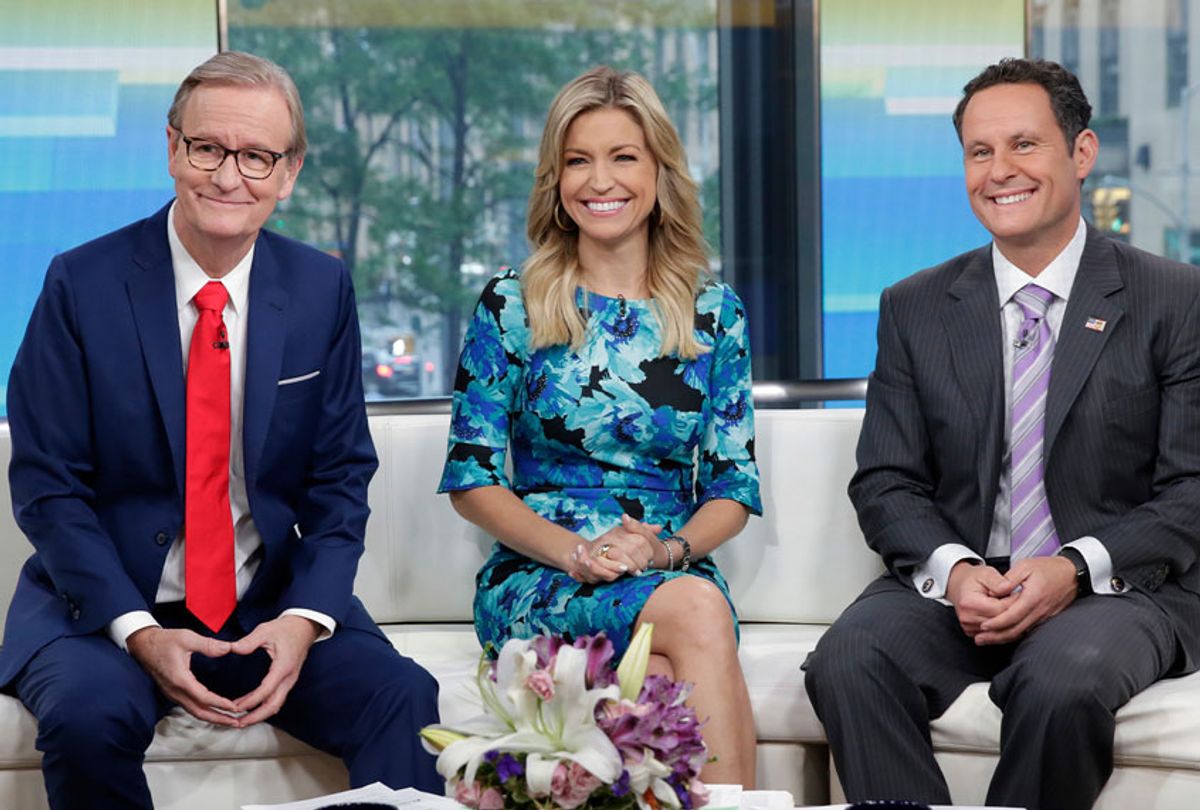 Co-hosts Steve Doocy, Ainsley Earhardt, and Brian Kilmeade, left to right, of the "Fox & friends" television program. (AP Photo/Richard Drew)