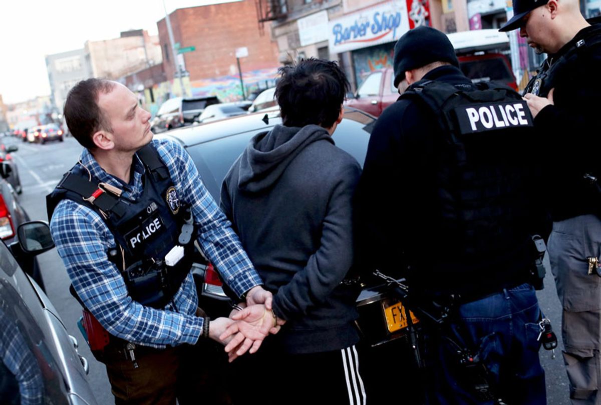 U.S. Immigration and Customs Enforcement (ICE), officers arrest an undocumented Mexican immigrant during a raid  (John Moore/Getty Images)
