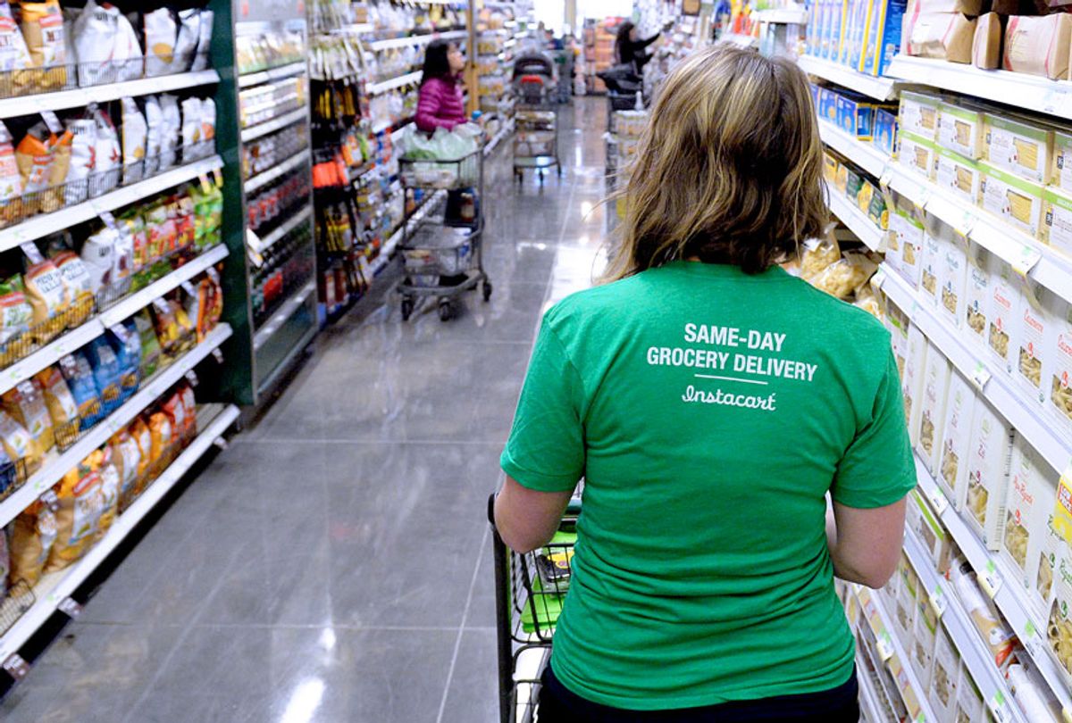 A shopper for Instacart navigates through the aisles as she shops for a customer at Whole Foods in Denver. They receive a grocery list for a shopper and then completes the shopping. (Denver Post Photo by Cyrus McCrimmon)