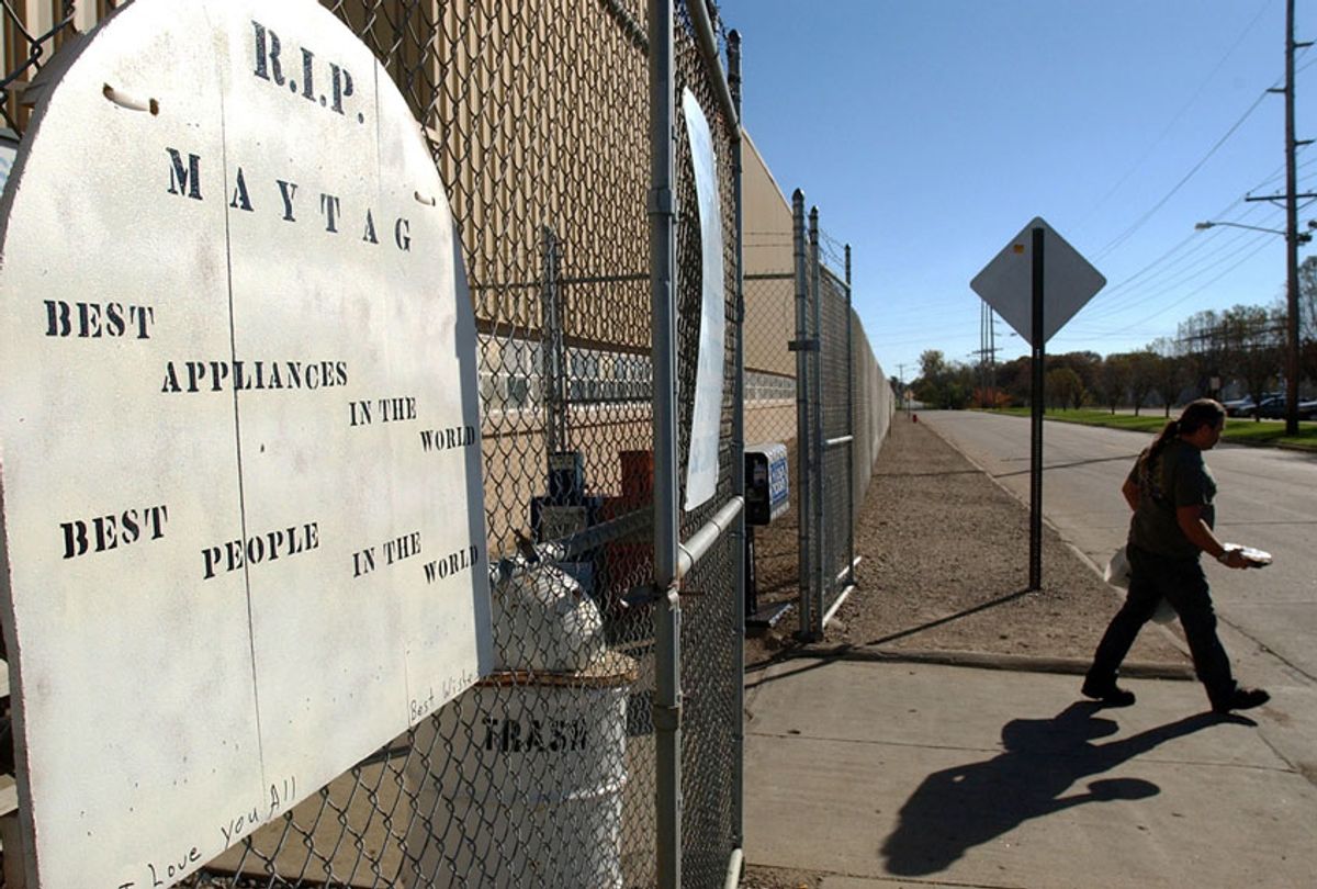 A R.I.P. sign hangs on the gate as a worker exits the plant on the eve of the final day of production at the Maytag plant in Newton, Iowa (AP Photo/Steve Pope)
