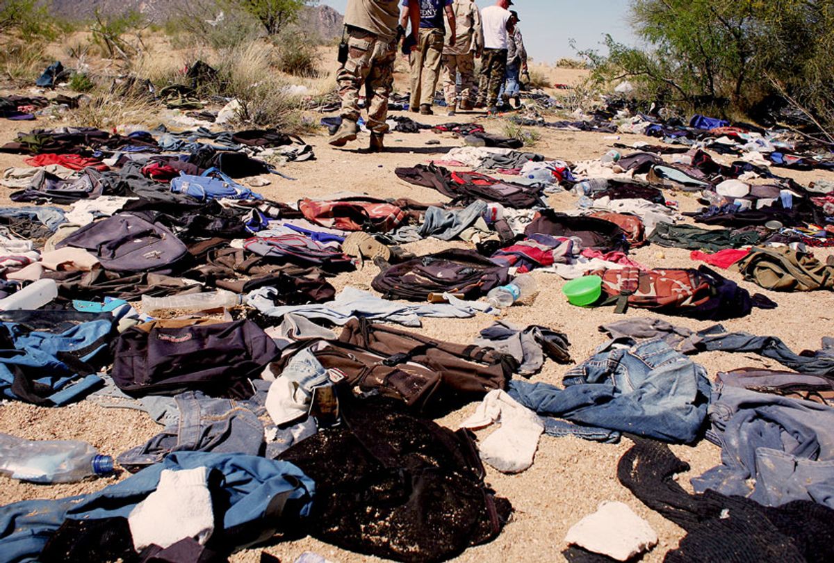 Minutemen pass through a stretch of remote Sonoran desert that has been damaged by groups of migrants having to discard clothing and medicine on their journey north. Thirty miles from the Mexican border, Minutemen volunteers from across America spend time patrolling a large private ranch in the Altar Valley of southern Arizona, searching for "illegal" migrants making their way north through the harsh desert terrain. Although most of the Minutemen carry guns, they are under strict instructions to not chase or apprehend migrants, but instead to report sightings to the border patrol. | Location: Three Points, Arizona, USA. (Andrew Lichtenstein/Corbis via Getty Images)