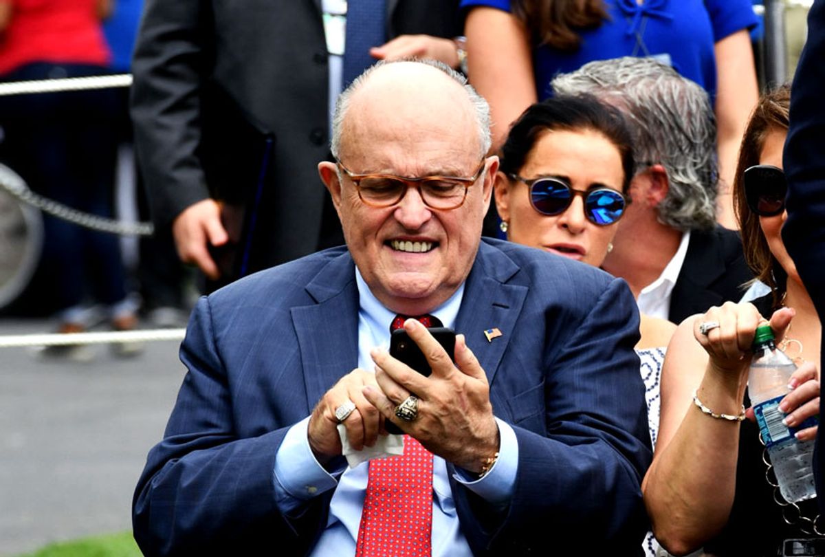 President Donald Trump's lawyer, Rudy Giuliani looks at his cellphone outside the White House on the South Lawn (NICHOLAS KAMM/AFP via Getty Images)