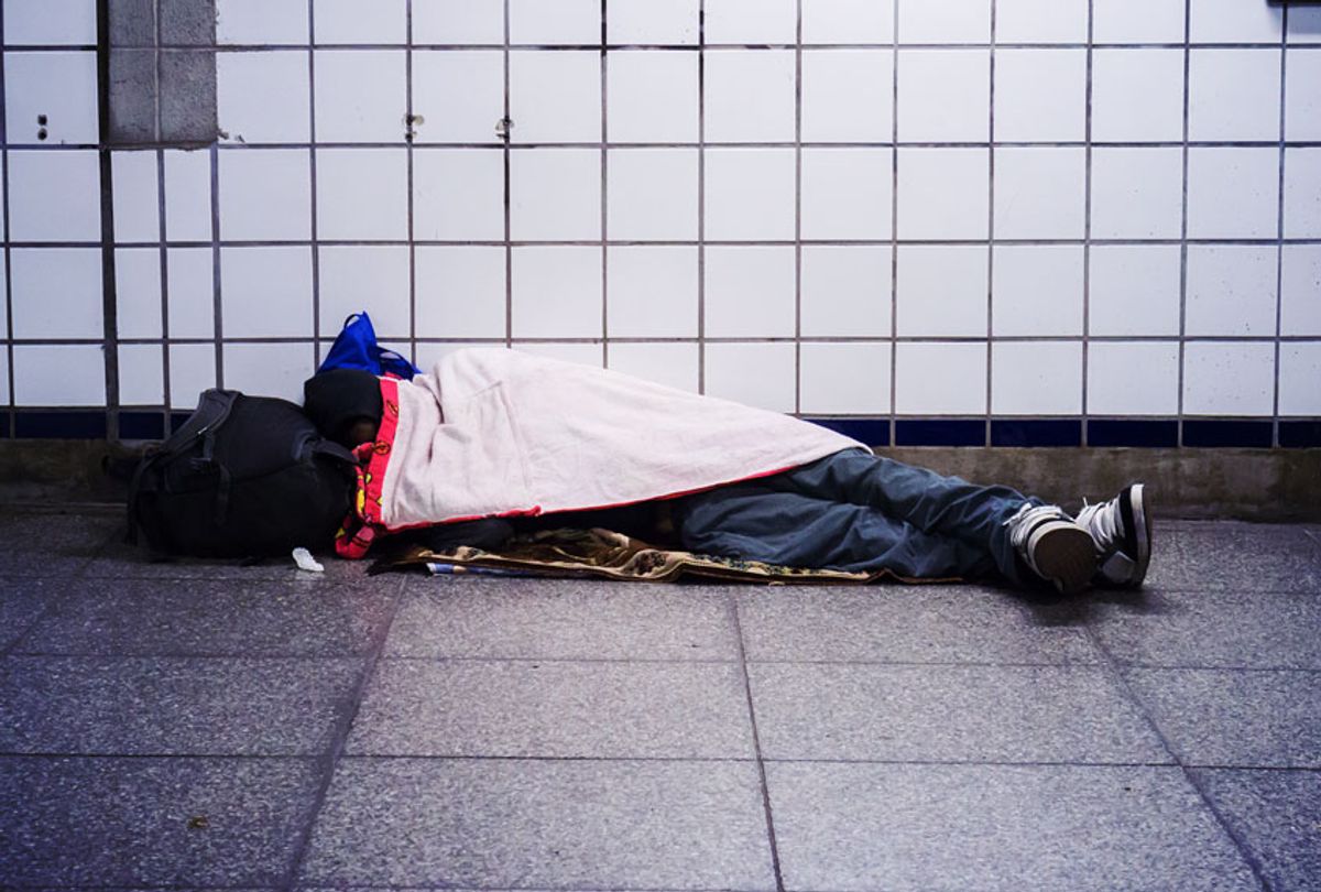 A homeless individual sleeps in a subway station in New York  (Richard Levine/Corbis via Getty Images)