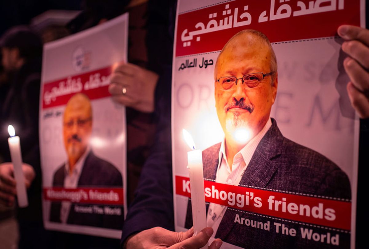 People hold posters picturing Saudi journalist Jamal Khashoggi and lightened candles during a gathering outside the Saudi Arabia consulate in Istanbul, on October 25, 2018. - Jamal Khashoggi, a Washington Post contributor, was killed on October 2, 2018 after a visit to the Saudi consulate in Istanbul to obtain paperwork before marrying his Turkish fiancee.  (YASIN AKGUL/AFP via Getty Images)