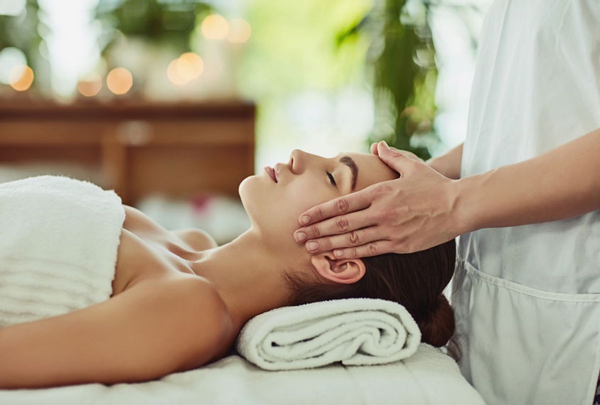 Shot of a young woman getting massaged at a beauty spa (Getty Images)