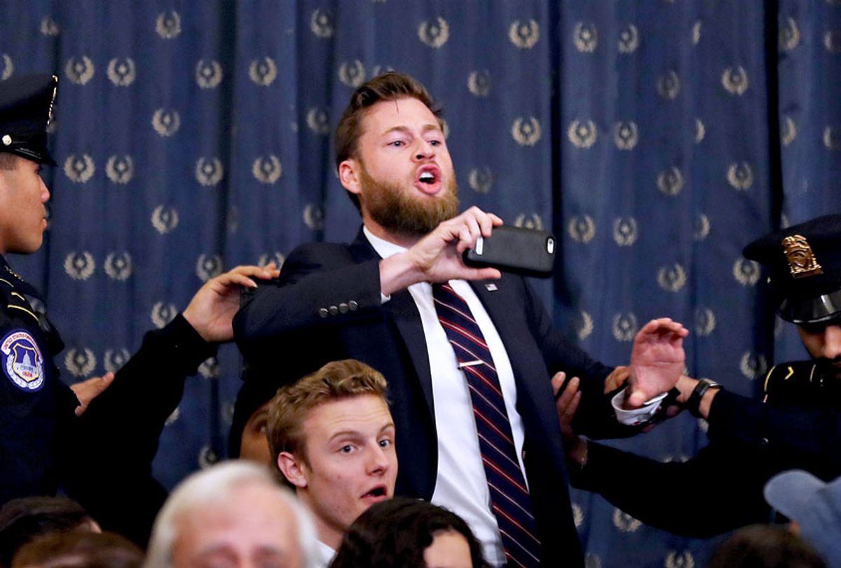 Infowars host Owen Shroyer shouts, 'Jerry Nadler and the Democrat party are committing treason against this country, and you can kick me out, but he's the one committing crimes" as he is removed by police after interrupting a House Judiciary Committee hearing on impeachment in the Longworth House Office Building on Capitol Hill December 9, 2019 in Washington, DC. The Judiciary Committee formally received evidence in the impeachment inquiry of President Donald Trump, whom Democrats say held back military aid for Ukraine while demanding they investigate his political rivals. The White House declared it would not participate in the hearing. (Chip Somodevilla/Getty Images)