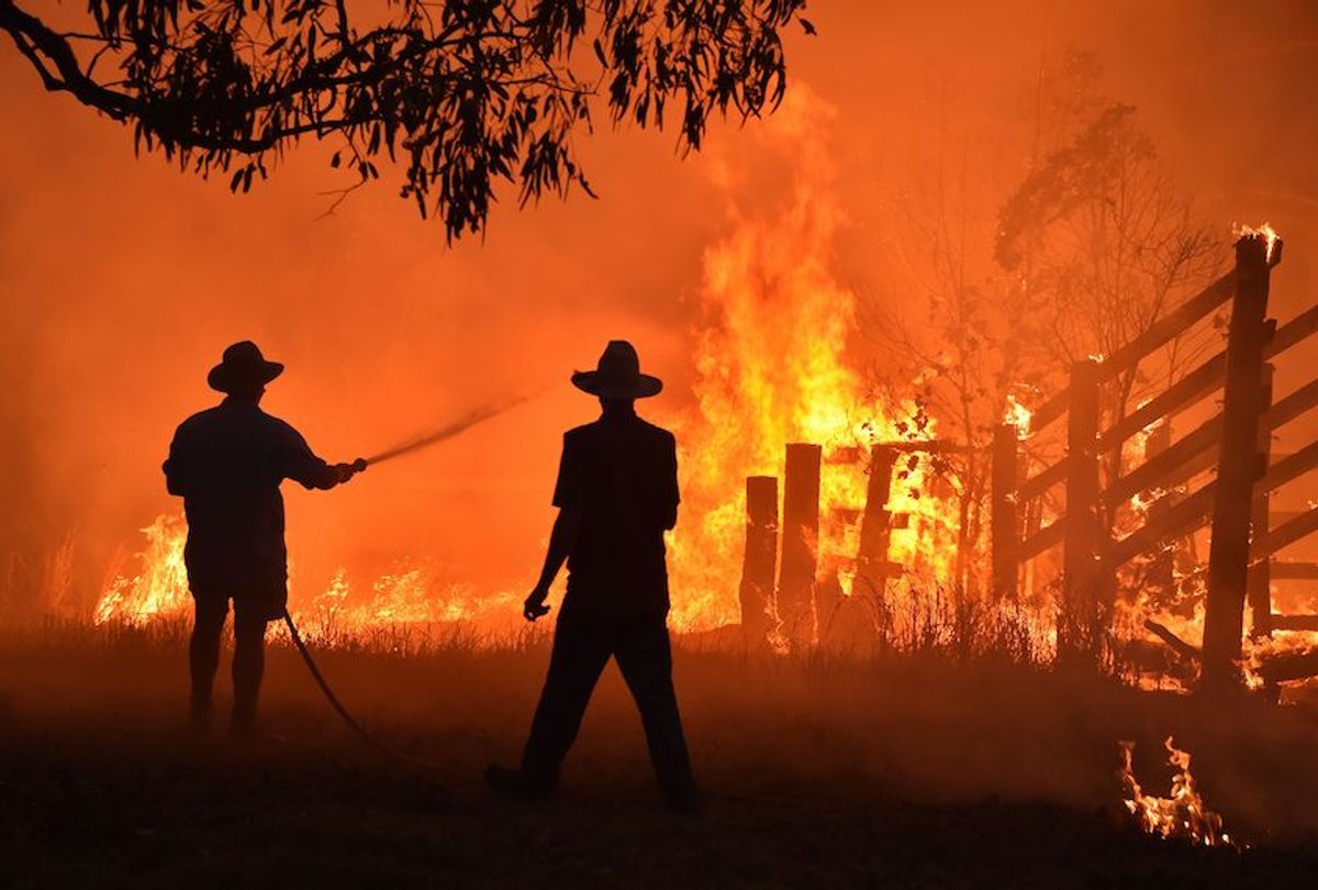 Residents defend a property from a bushfire at Hillsville near Taree, 350km north of Sydney on November 12, 2019. - A state of emergency was declared on November 11 and residents in the Sydney area were warned of "catastrophic" fire danger as Australia prepared for a fresh wave of deadly bushfires that have ravaged the drought-stricken east of the country. (Photo by PETER PARKS / AFP) (Photo by PETER PARKS/AFP via Getty Images) (Peter Parks/AFP via Getty Images)