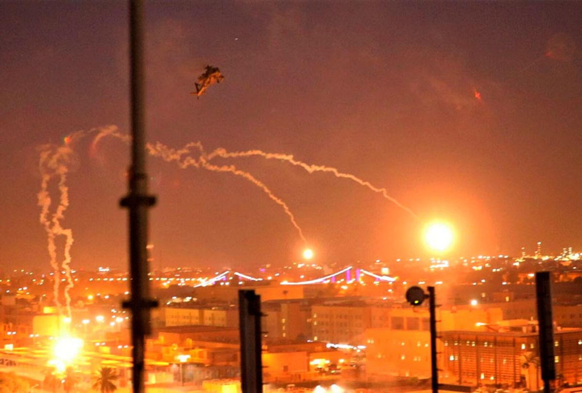 In this photo provided by U.S. Department of Defense, the Army's AH-64 Apache helicopter from 1st Battalion, 227th Aviation Regiment, 34th Combat Aviation Brigade, conducts overflights of the U.S. Embassy in Baghdad, Iraq, Tuesday, Dec. 31, 2019. The helicopters launched flares as a show of presence while providing additional security and deterrence against protesters.  (U.S. Army photo by Spc. Khalil Jenkins, CJTF-OIR Public Affairs via AP)