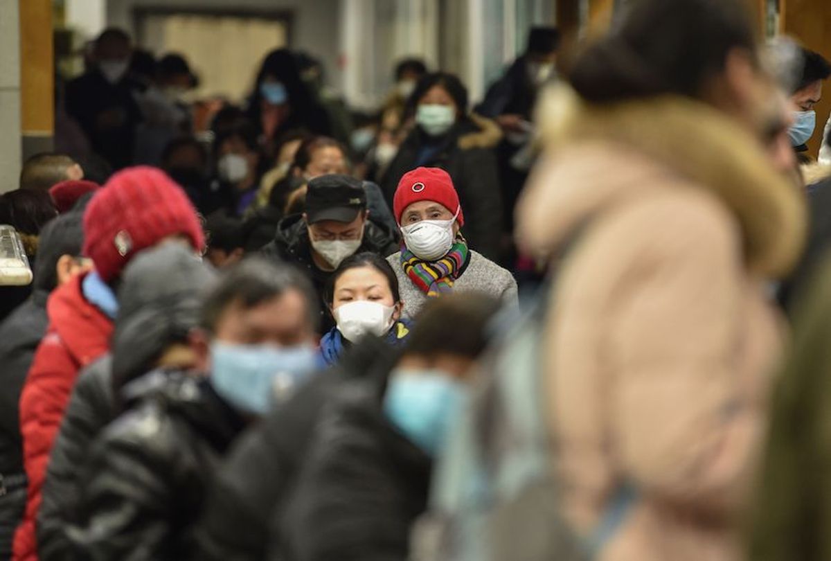 People wearing facemasks to help stop the spread of a deadly virus which began in the city, wait at Wuhan Red Cross Hospital in Wuhan on January 24, 2020. (Hector Retamal/AFP via Getty)