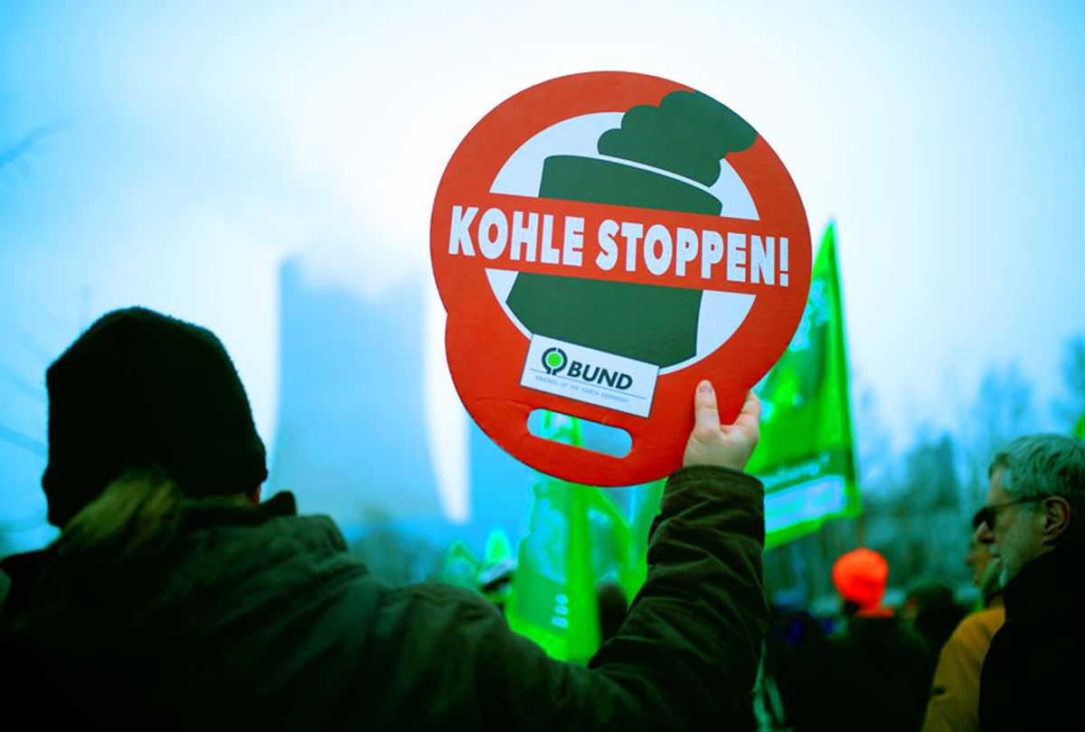 A supporter of Fridays for Future movement holds a placard reading "stop coal" during a demonstration against the commissioning of the coal-fired power plant Datteln 4 in Datteln, western Germany on January 24, 2020. (INA FASSBENDER/AFP via Getty Images)