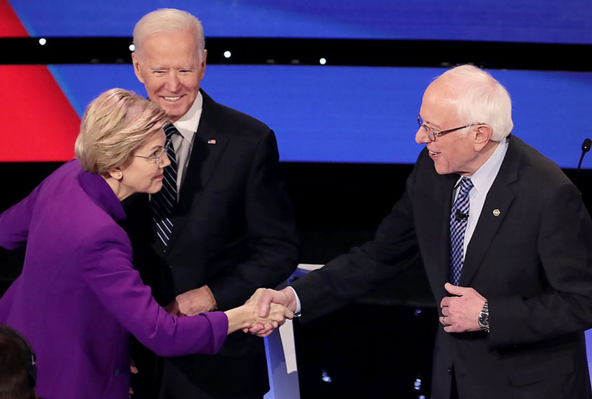 Sen. Elizabeth Warren (D-MA) greets Sen. Bernie Sanders (I-VT) (R) as former Vice President Joe Biden looks on ahead of the Democratic presidential primary debate at Drake University on January 14, 2020 in Des Moines, Iowa. Six candidates out of the field qualified for the first Democratic presidential primary debate of 2020, hosted by CNN and the Des Moines Register.  (Scott Olson/Getty Images)