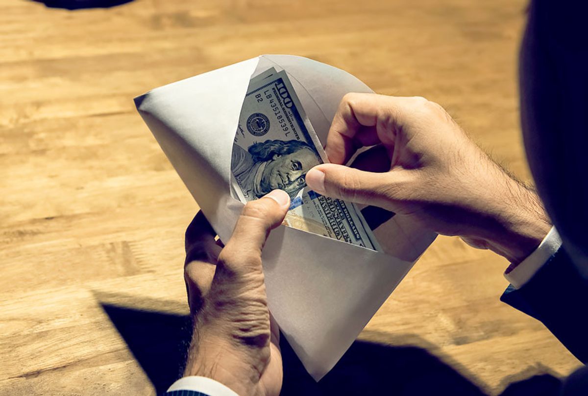 Money in an envelope (Getty Images/Kritchanut)