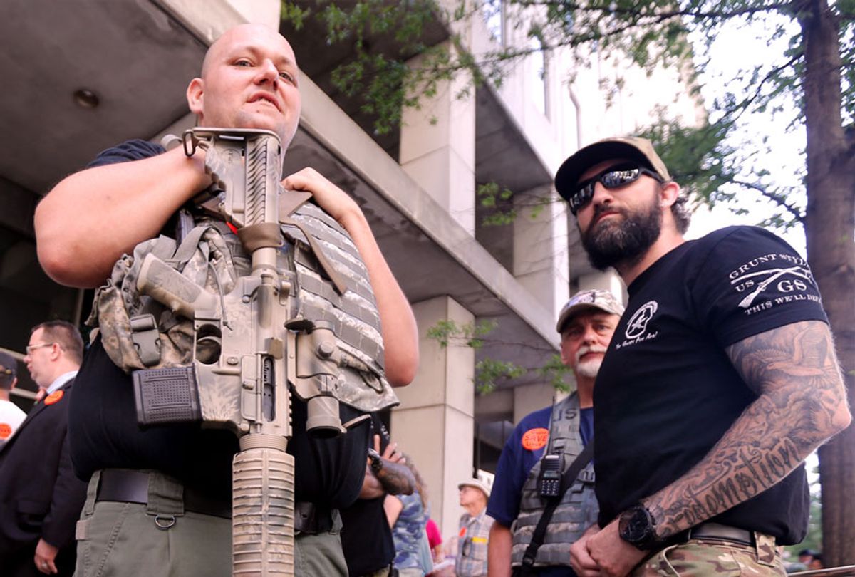 Gun rights supporters hold weapons outside the Capitol office building at the State Capitol in Richmond, Va. (Win McNamee/Getty Images)