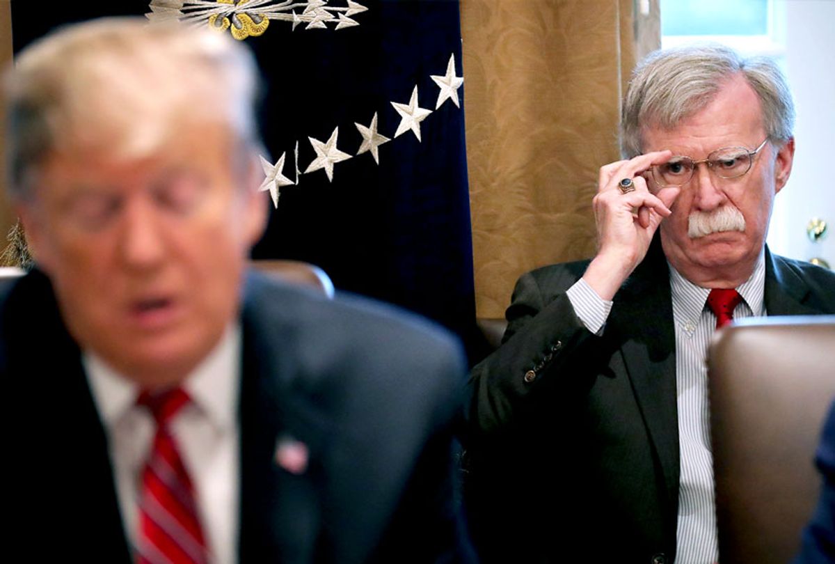 National Security Advisor John Bolton (R) listens to U.S. President Donald Trump talk to reporters during a meeting of his cabinet in the Cabinet Room at the White House (Chip Somodevilla/Getty Images)