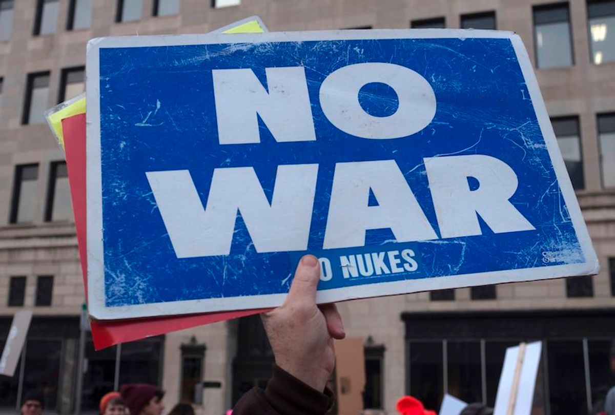 A person holds up a sign reading "now war" as protesters gather near the Huntington Center in Toledo, Ohio January 9, 2020. (Seth Herald/AFP via Getty Images)