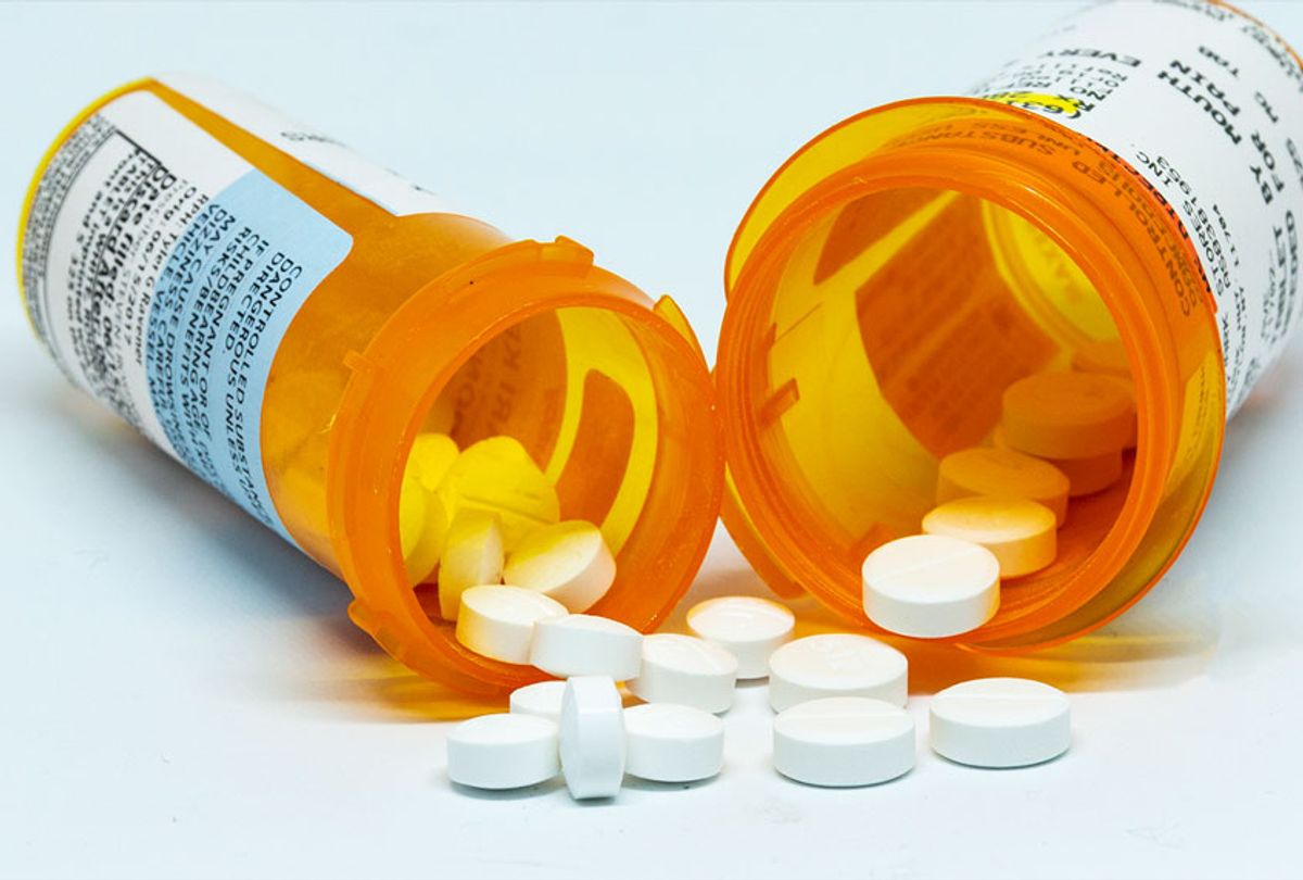 Two prescription bottles with pain pills spilling out of them (Getty Images)