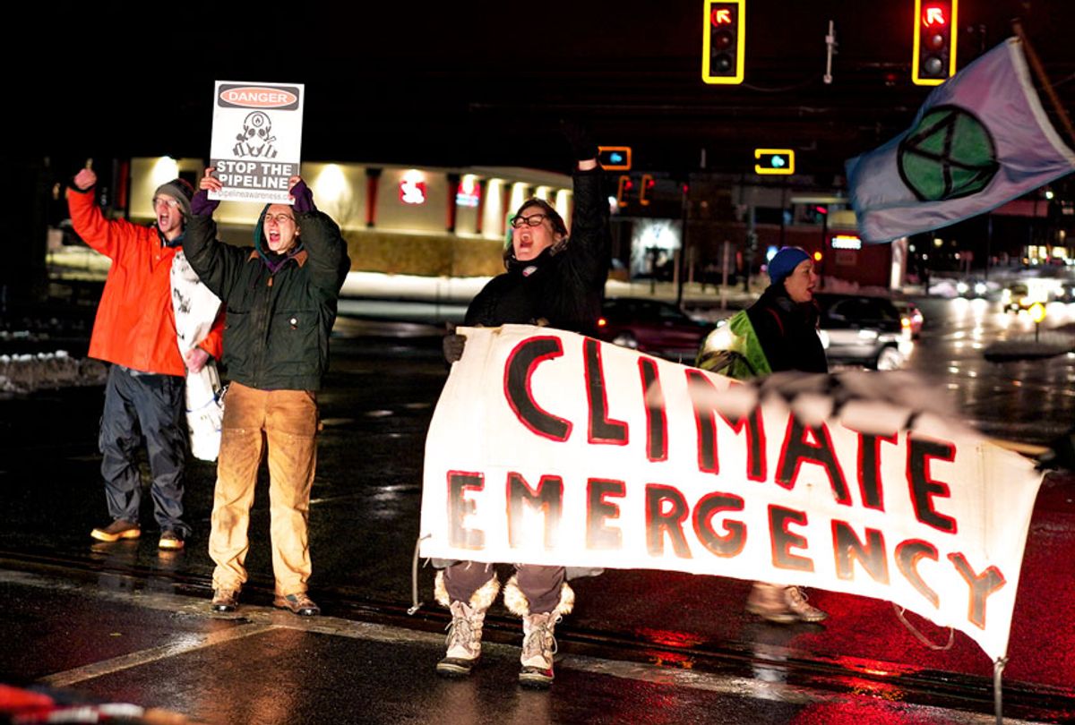 Activists rally at a busy intersection prior to the Democratic in Manchester, NH on February 7, 2020. The marchers were concerned that climate change is not being discussed and addressed. (Bonnie Jo Mount/The Washington Post via Getty Images)