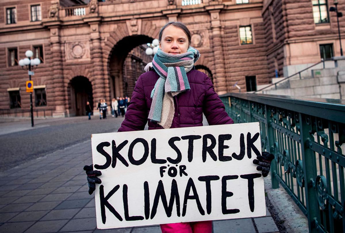 17-years-old Swedish climate activist Greta Thunberg holds a poster reading "School strike for Climate" as she protests in front of the Swedish Parliament, where she goes on school strike on January 10, 2020 in Stockholm.  (JONATHAN NACKSTRAND/AFP via Getty Images)